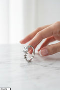 Silver ring with a large diamond on a marble surface