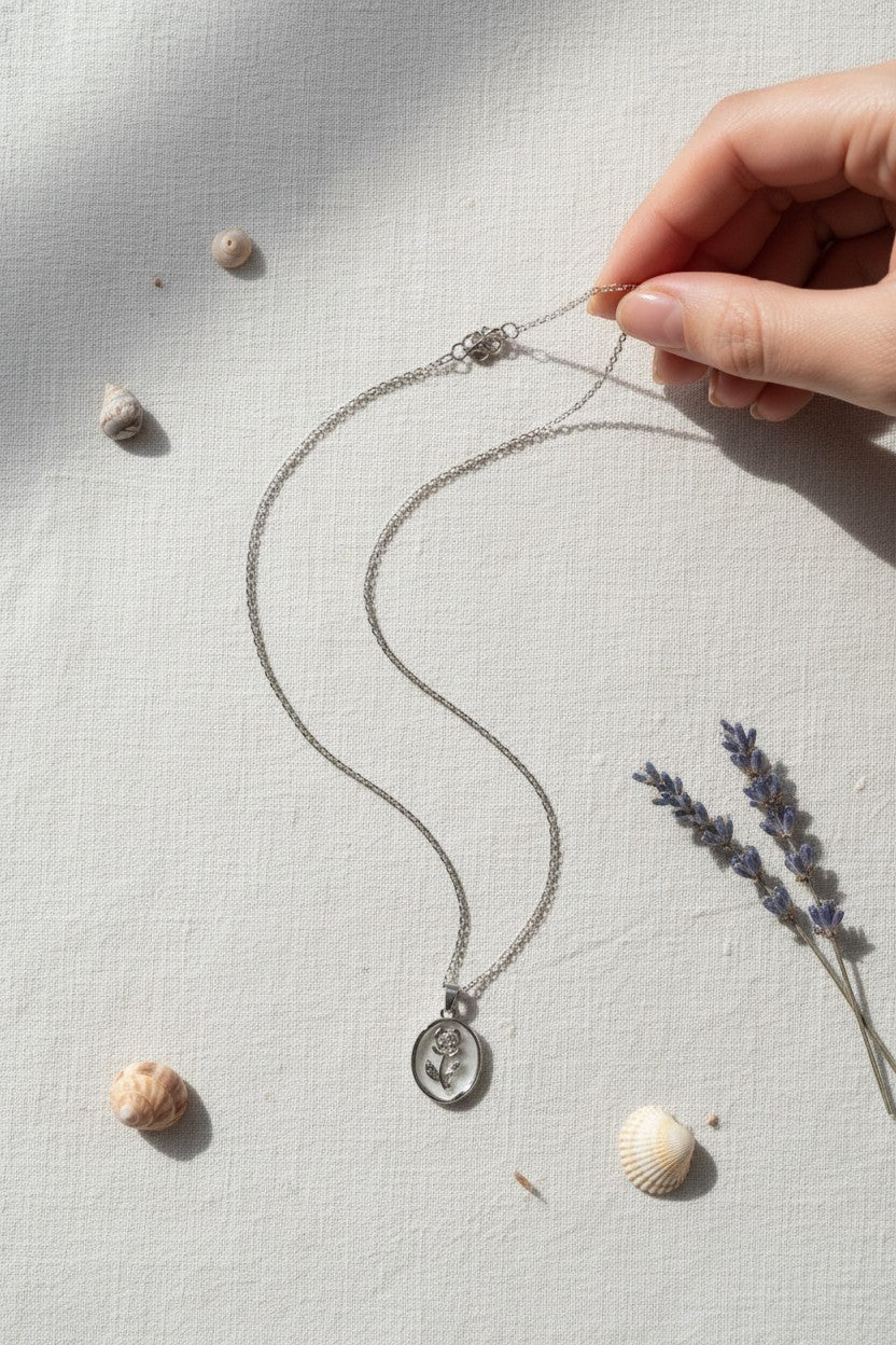 Ownline Galleria sterling silver oval pendant necklace with engraved rose motif on a fine chain.