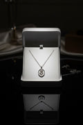 Ownline Galleria sterling silver oval pendant necklace with rose engraving in a gift box.