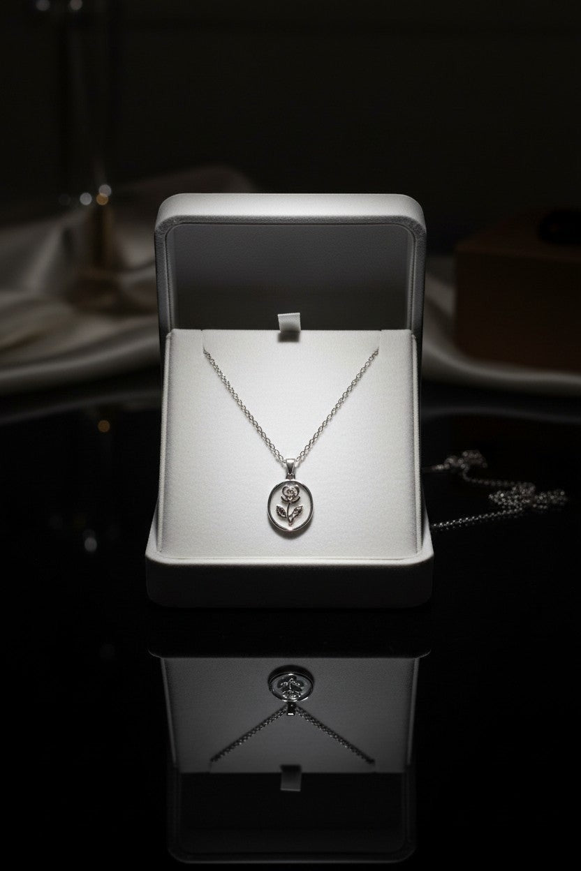 Ownline Galleria sterling silver oval pendant necklace with rose engraving in a gift box.