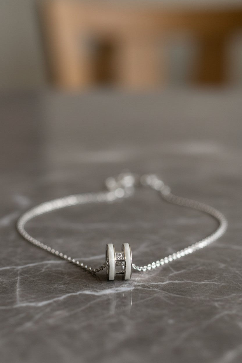 Ownline Galleria sterling silver necklace with a white cylindrical charm accented with crystals. Delicate chain.