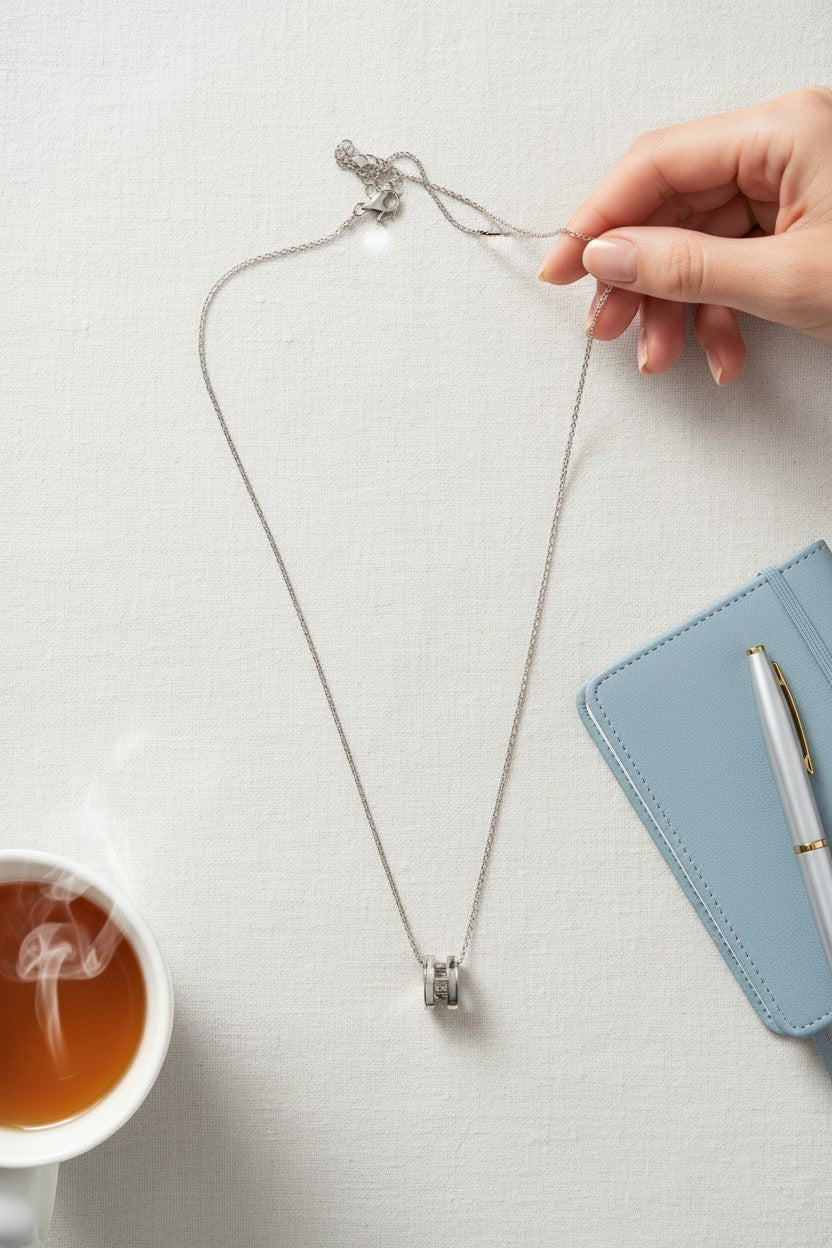 Ownline Galleria sterling silver pendant necklace with cylindrical charm and crystal accents on a delicate chain.