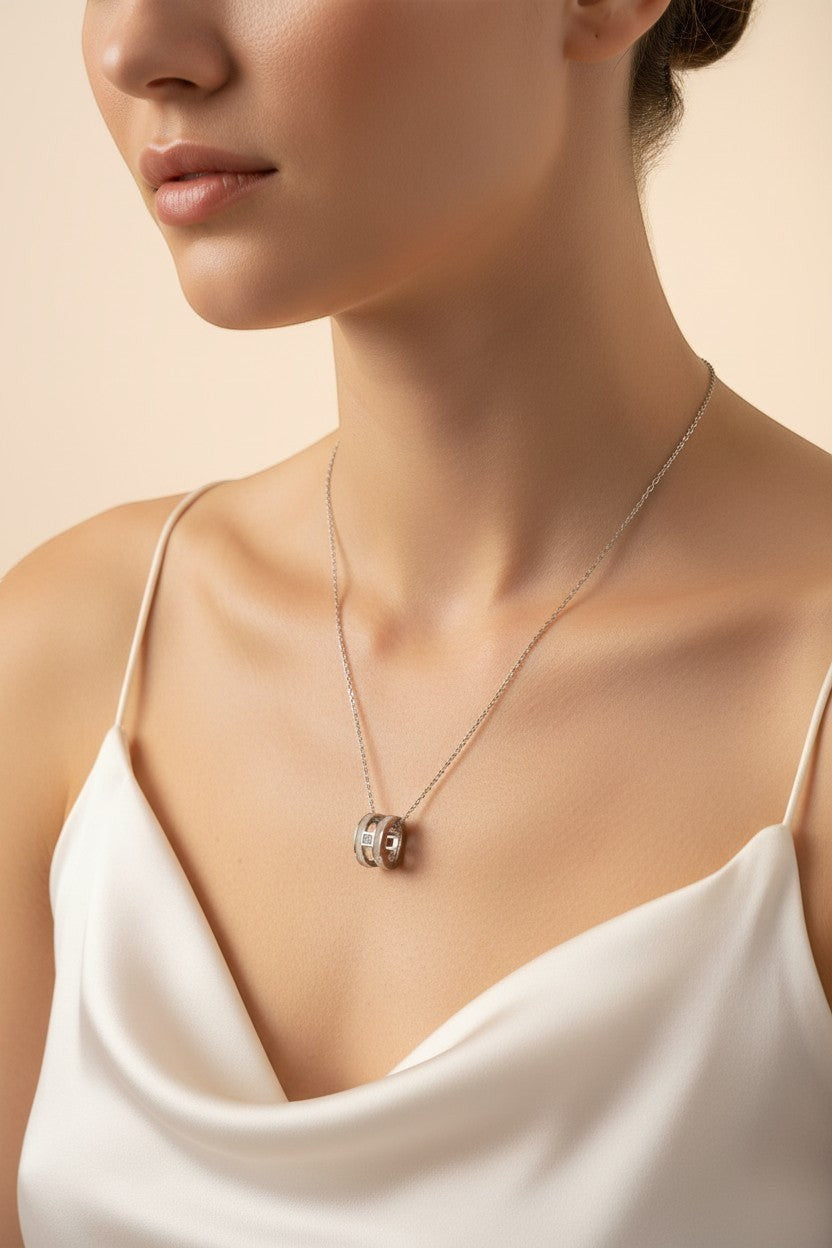 Ownline Galleria sterling silver pendant necklace with cylindrical charm and crystal accents on a delicate chain.